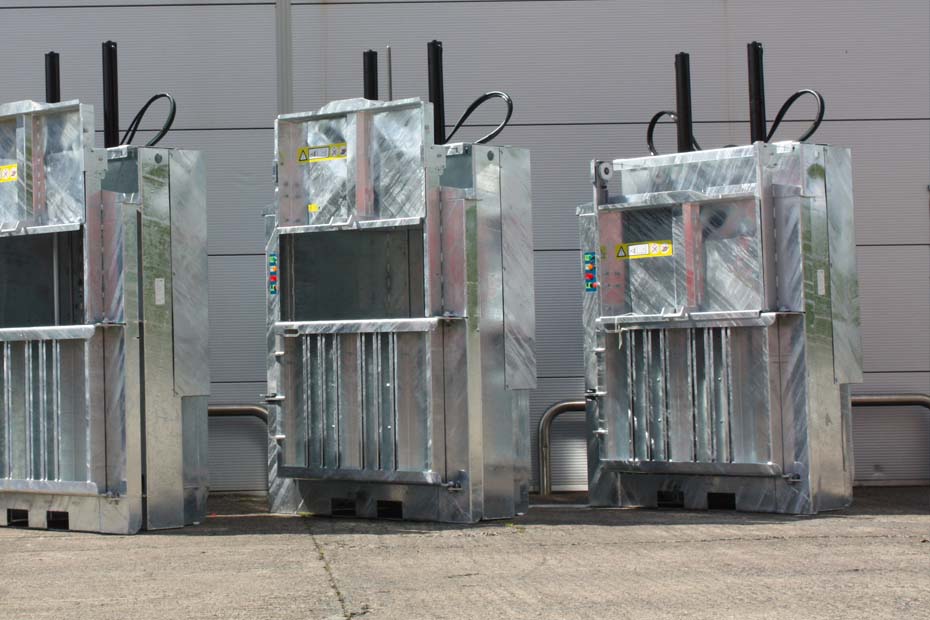 a row of galvanised vertical balers